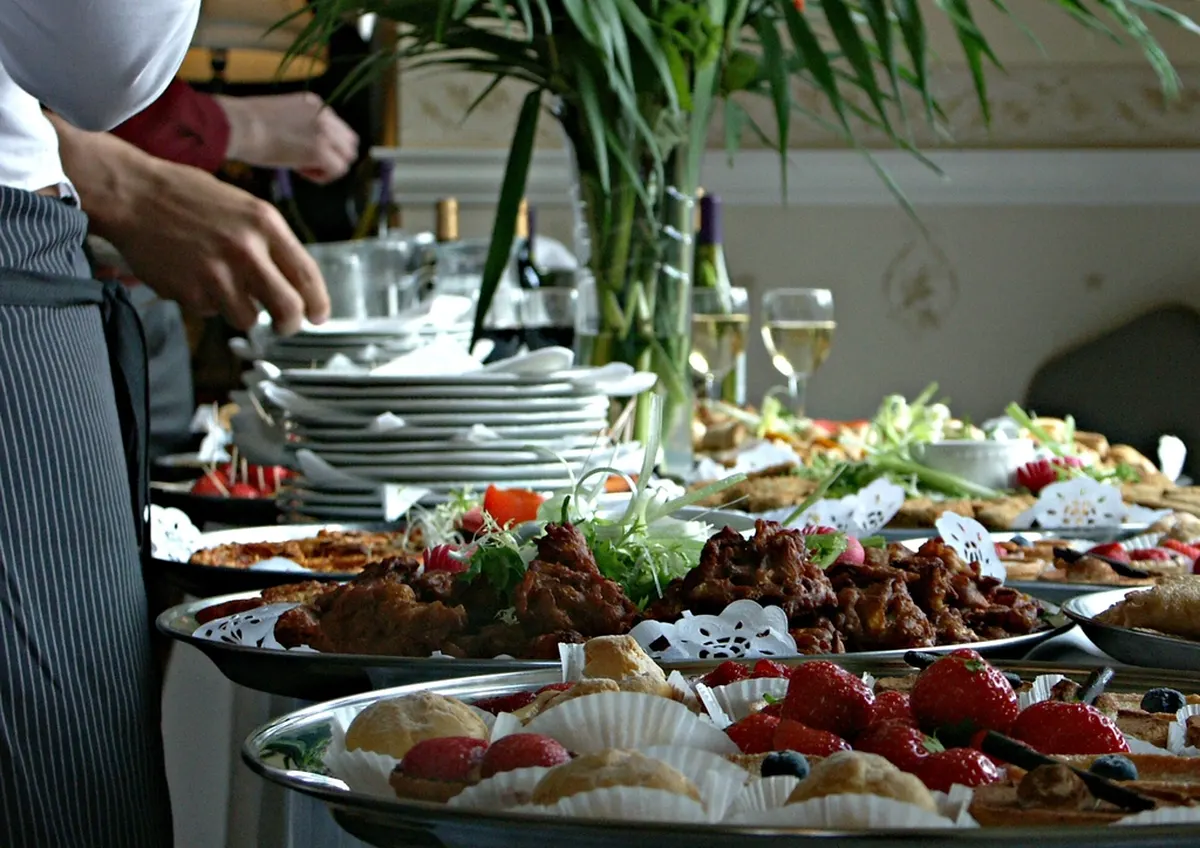 buffet table with plated dishes and garnishes