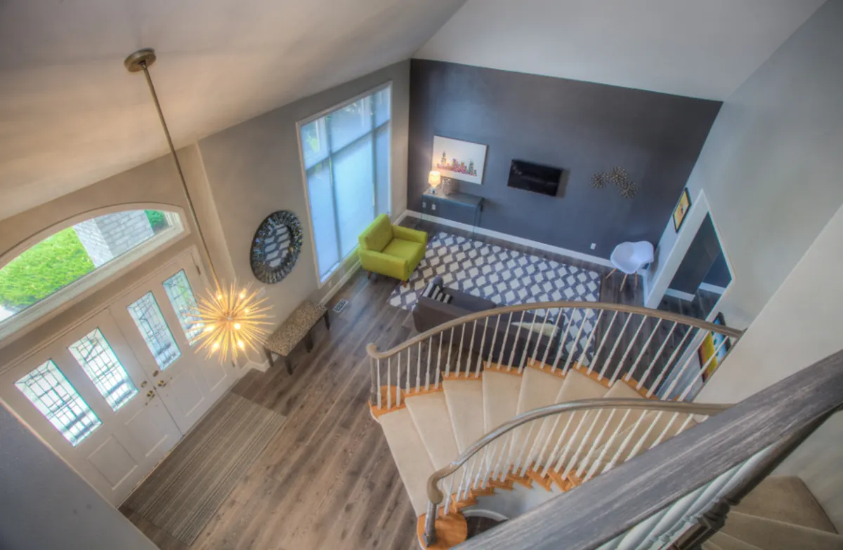 sunny living room seen from above a staircase