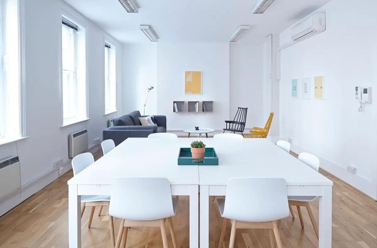 bright white dining area with chairs and large windows