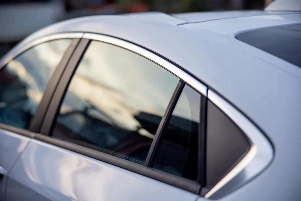 silver car body panel and window reflection