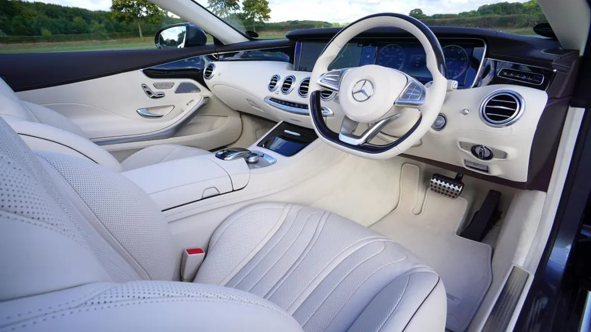 clean white leather car interior with dashboard