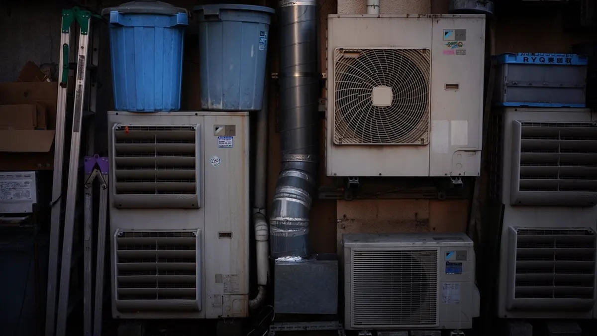 outdoor air conditioning condenser units mounted on a wall