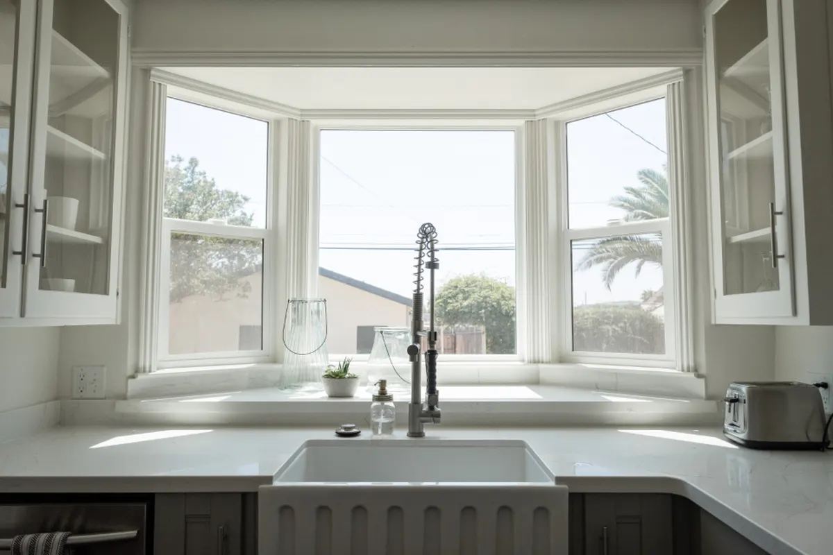 bright kitchen sink under a bay window