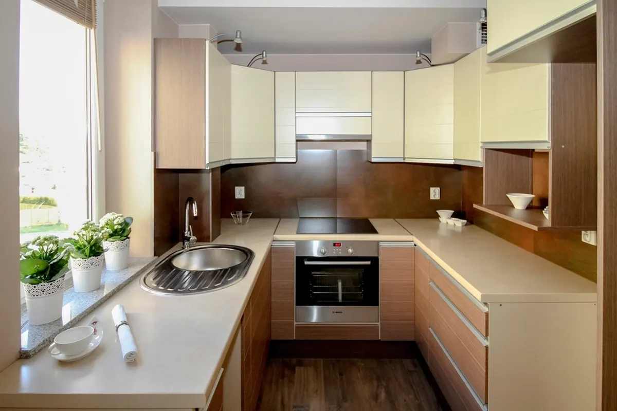 modern kitchen with wood cabinets and plants