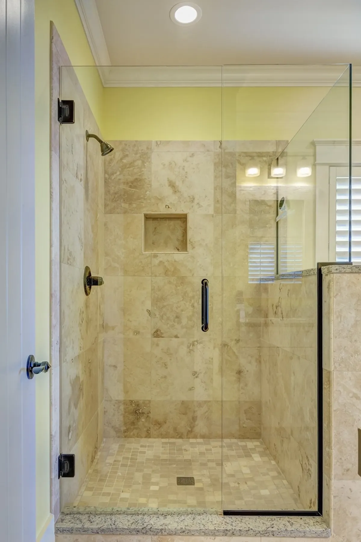 glass shower with beige tile