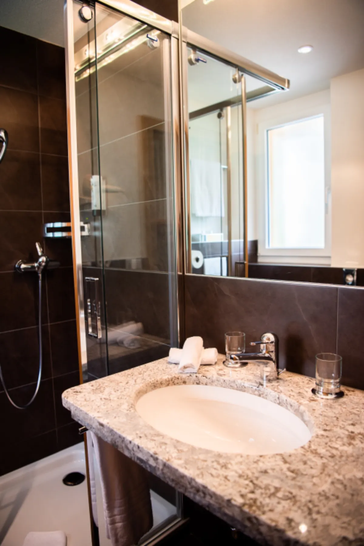 vanity with stone countertop and mirror