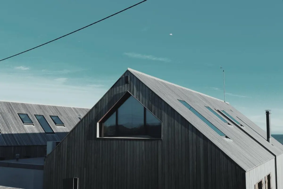 modern gabled house roof against a blue sky