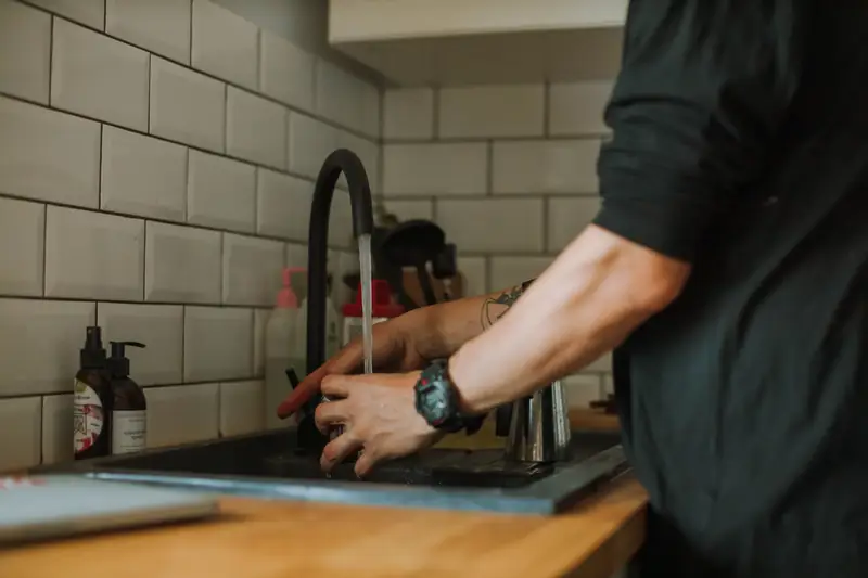 Technician installing a kitchen faucet