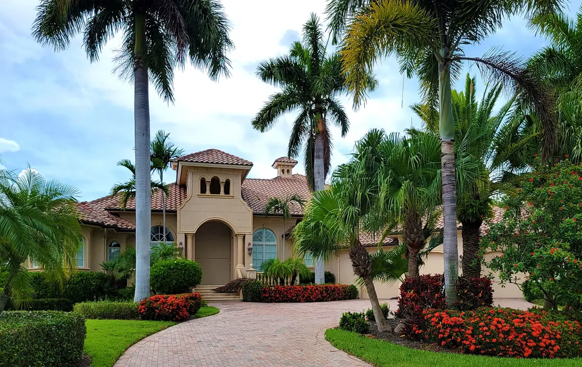 Palm-lined Naples estate with manicured tropical landscaping
