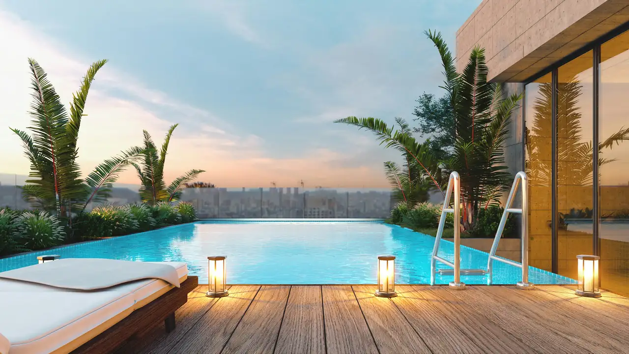 Infinity-edge pool and teak deck glowing at sunset