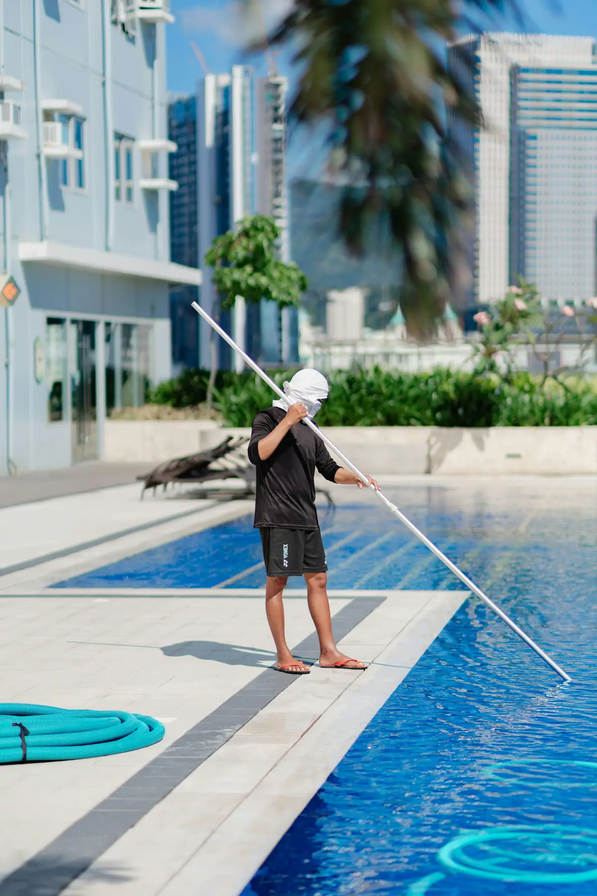 Tidewater technician skimming a residential pool