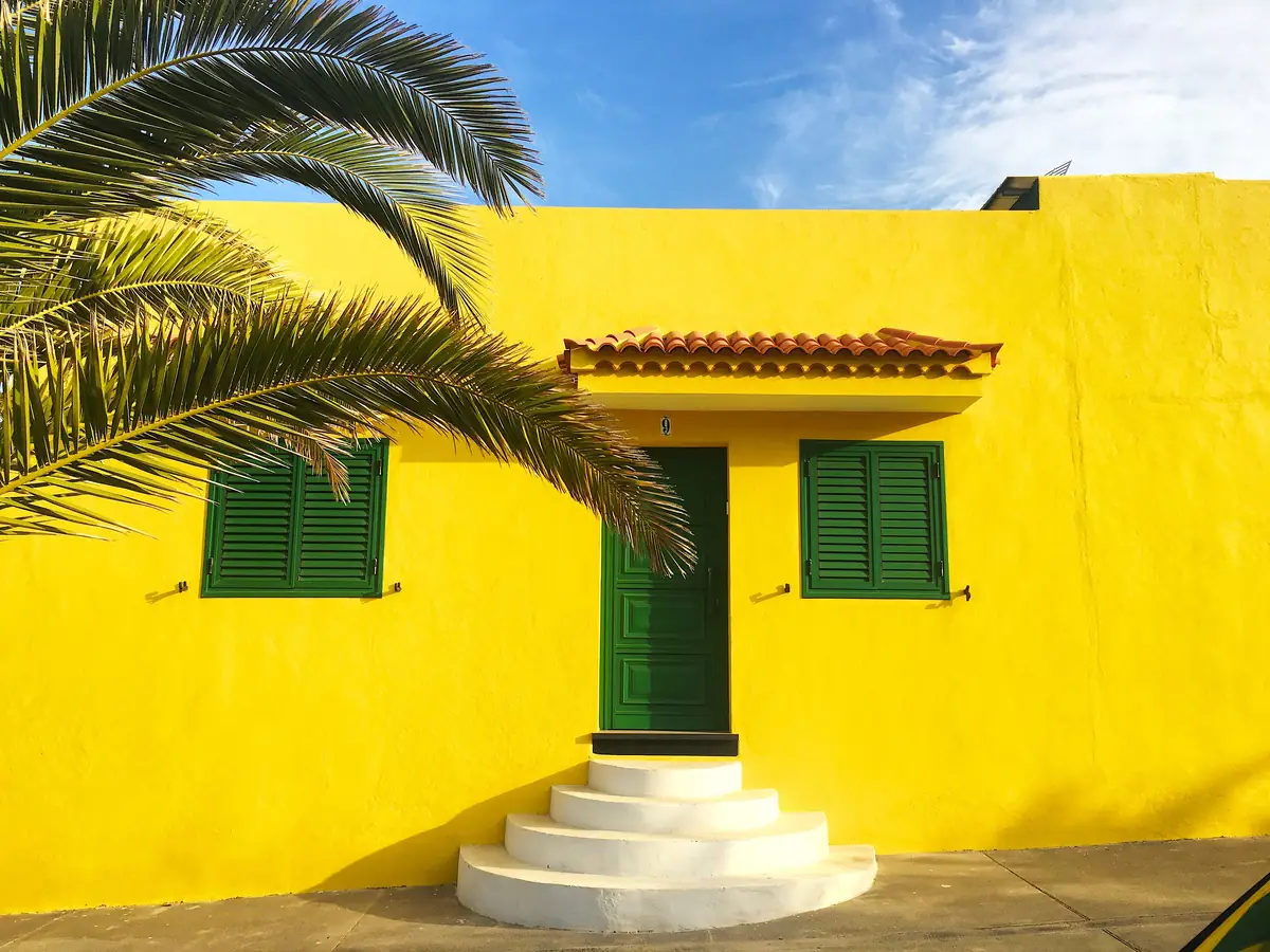 After: faded chalky wall repainted a bright, even yellow