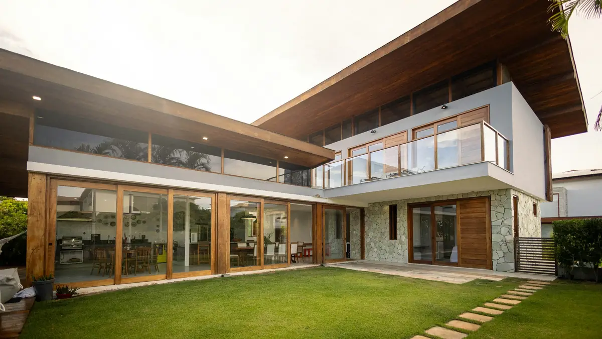 modern home with timber soffits opening onto a lawn courtyard